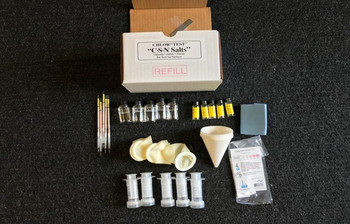 A complete refill kit for chloride, sulfate, and nitrate testing displayed on a clean industrial table. The kit includes premeasured components and the patented CHLOR*EXTRACT™ solution, ensuring precise contamination retrieval. The background features industrial testing tools, emphasizing the kit's compatibility with existing systems like CHLOR*TEST.